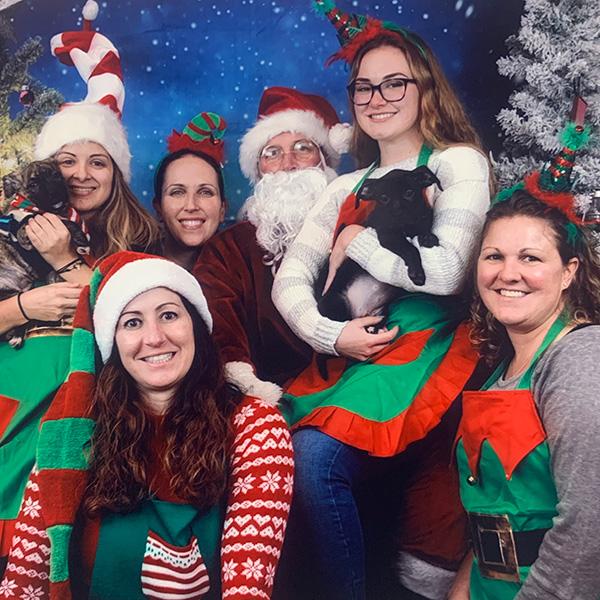 a group of women in elf clothing posing for a photo